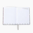 Open notebook with lined pages on a white background showing scripture inserts 